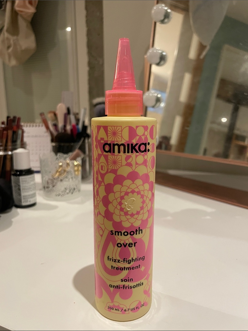 amika Smooth Over Frizz-Fighting Treatment — Pink & Yellow Bottle